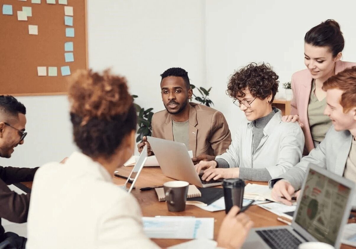 Diverse Employees Team Engaged in Teamwork in Modern Boardroom Diverse Employees Team Engaged in Teamwork in Modern Boardroom